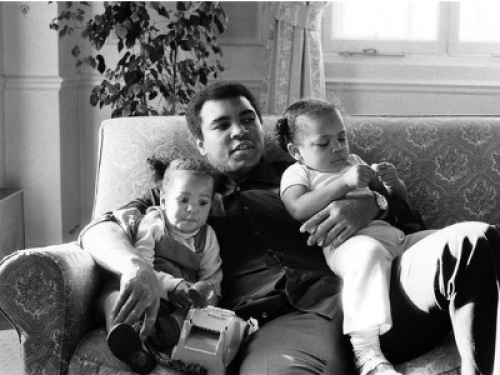 Ali with his children on his lap.