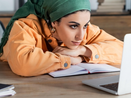 woman focused on online webinar while learning at home