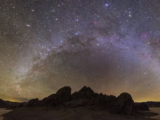 Photograph of the Milky Way over mountains.