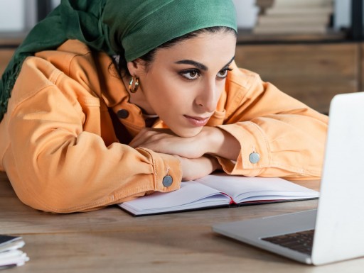 woman focused on online webinar while learning at home