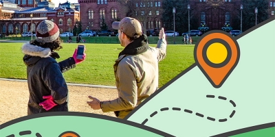 woman and man using app in front of the Smithsonian Castle