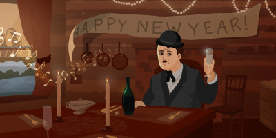 A man sits at a table wearing a black hat and suit and holding up a glass of champagne.