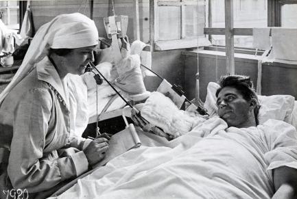 Nurse writing a letter for wounded soldier