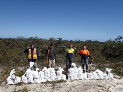 Researchers with bags of soil samples