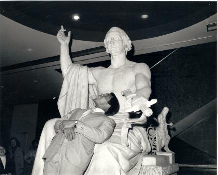 Ali looking up at statue of Washington