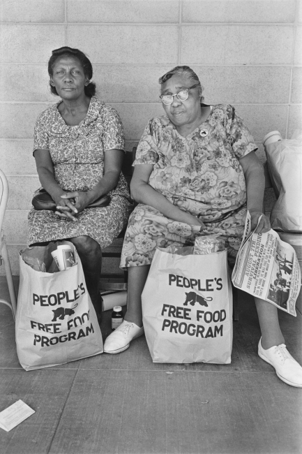 Two women with bags of food