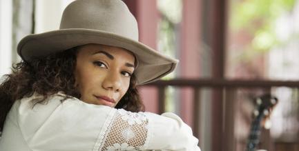 Promotional photo of Redbone wearing a hat