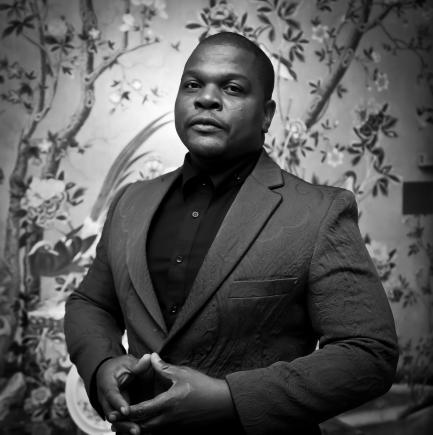 Black and white portrait of artist Kehinde Wiley