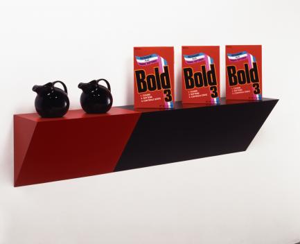 red and black sculpture featuring detergent boxes and pitchers