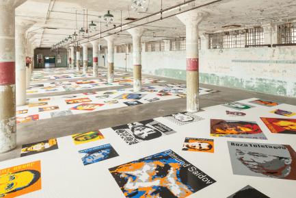 art exhibition with posters on white floor