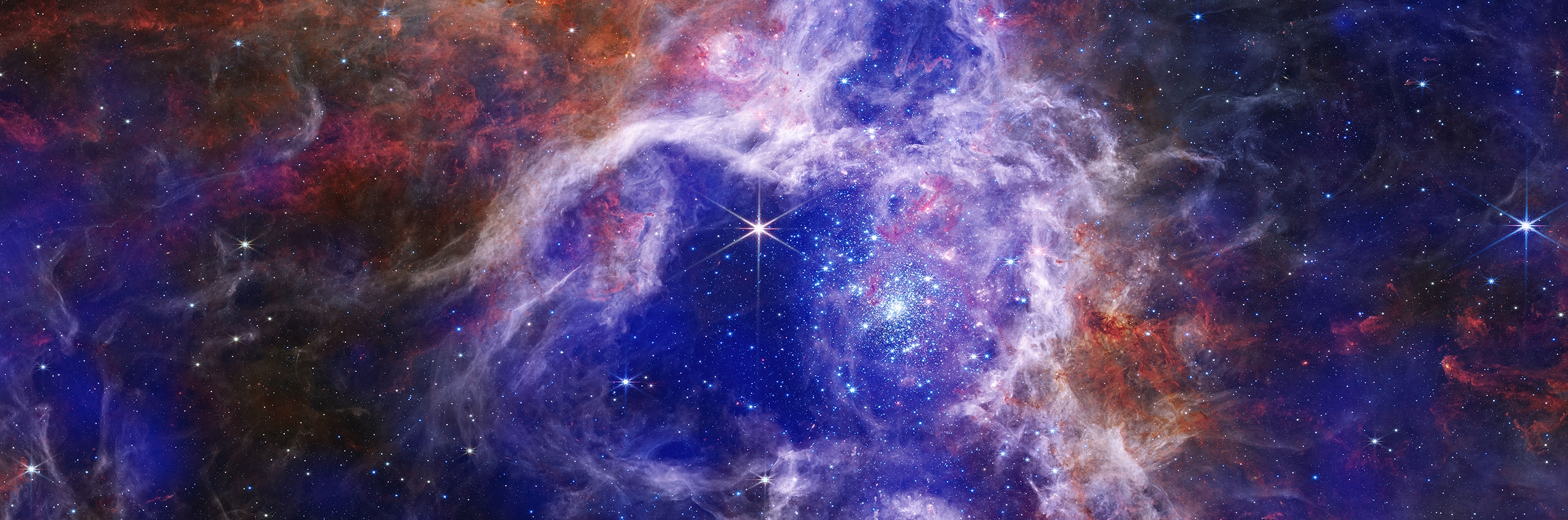 view of stars in space with swirling blue and red colors