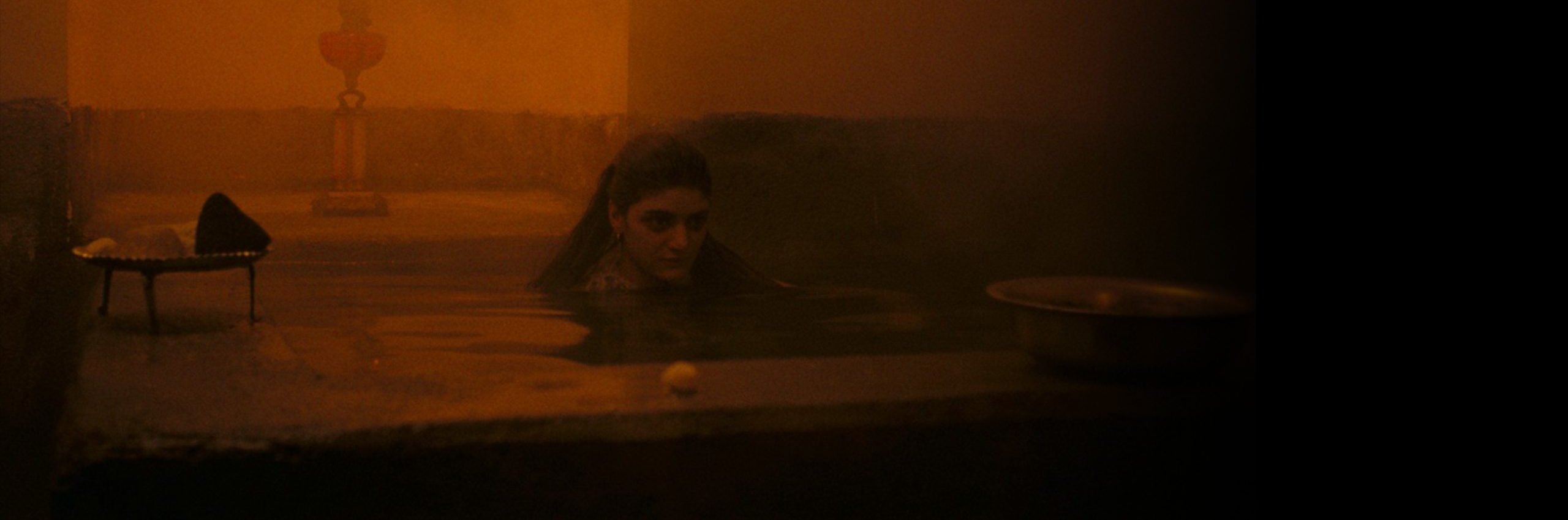 woman in water in a dark room