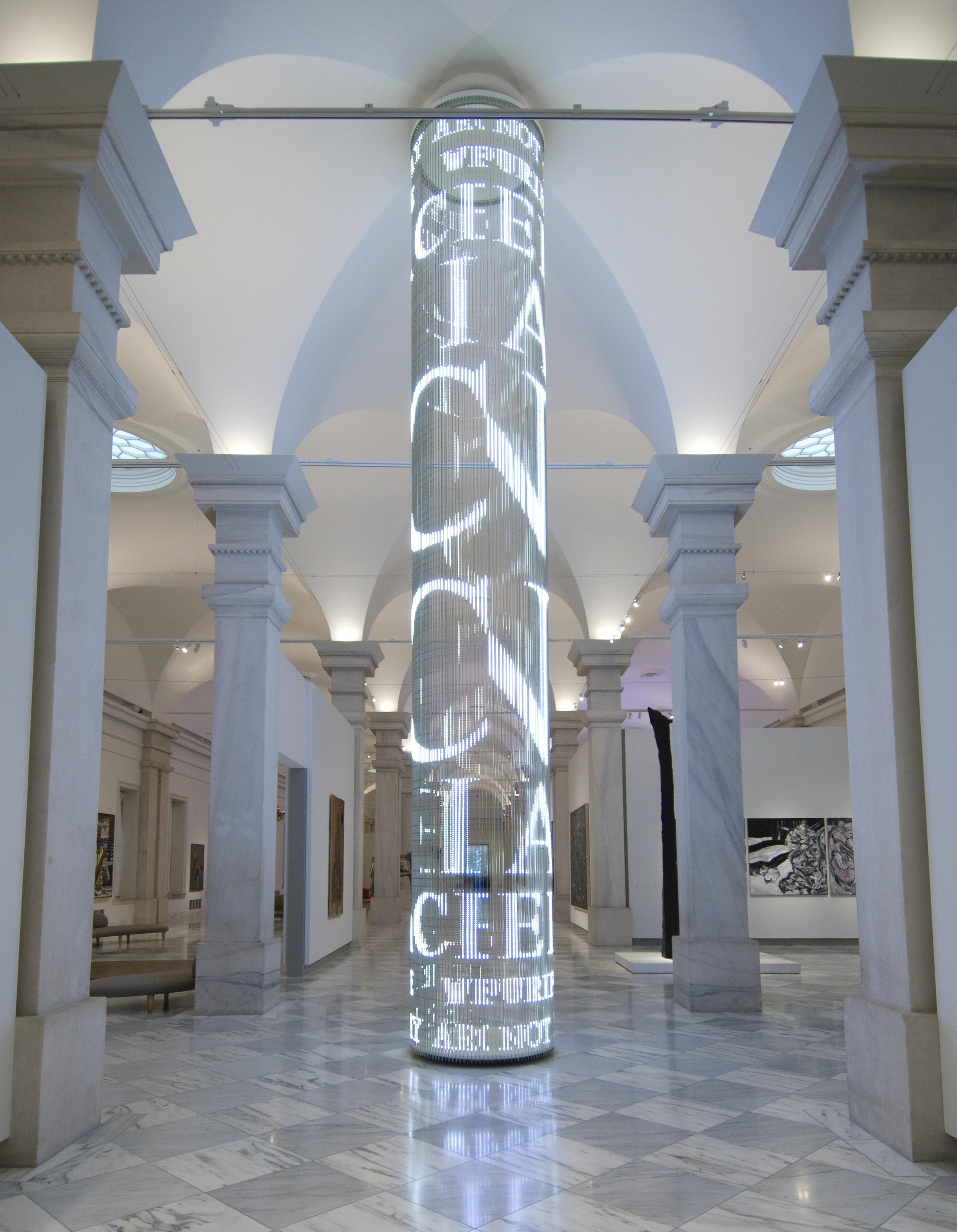 Cylindrical tower of animated LED lights that display the text phrases of the artwork.